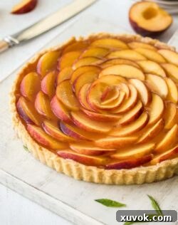 This Panna Cotta Fresh Peach Tart is delicate layers of cream cheese panna cotta, fresh peach slices and homemade peach jelly In a perfect tart shell.