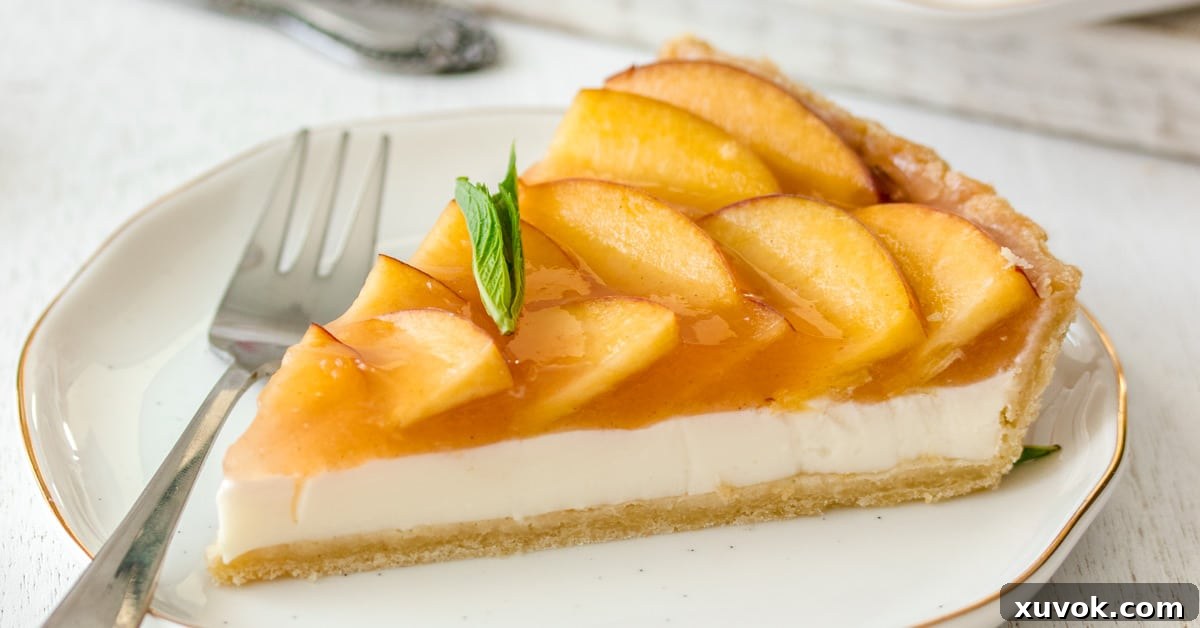 Closeup of a slice of Panna Cotta Fresh Peach Tart showing the distinct layers