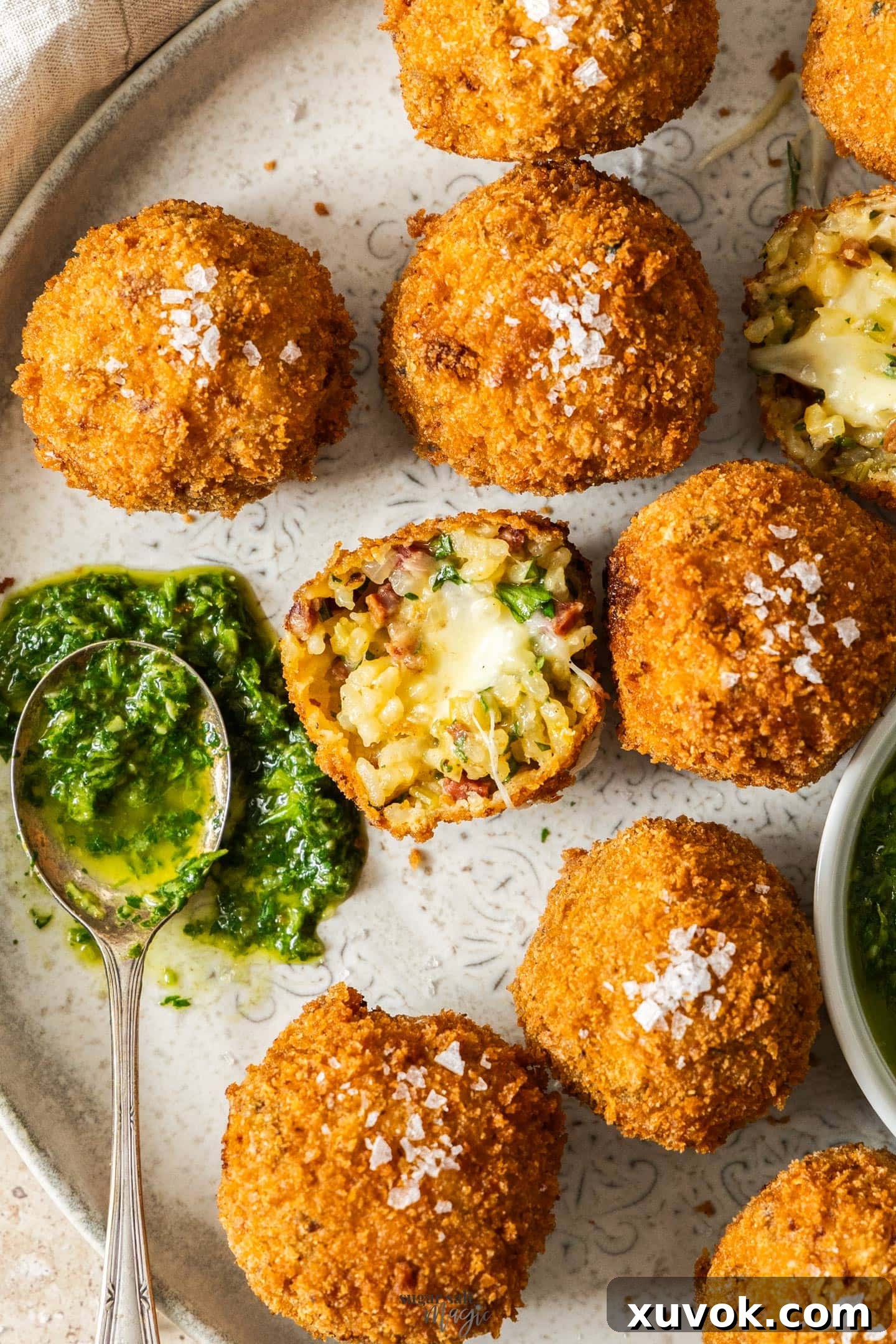 Chorizo arancini broken in half, showing gooey cheese interior.