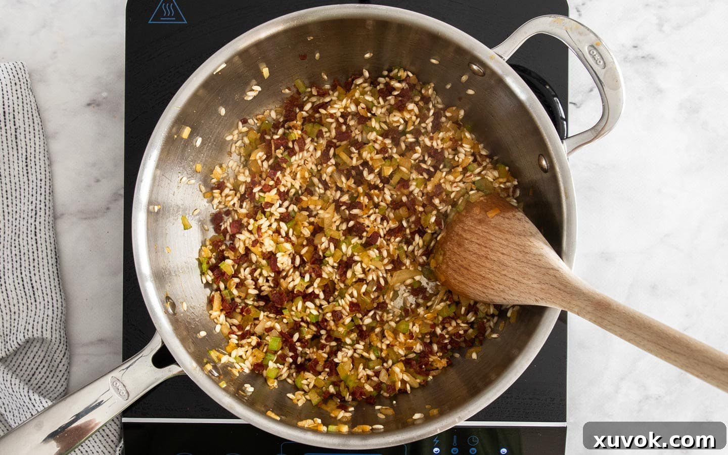 Arborio rice toasting in the pan with aromatics and chorizo.