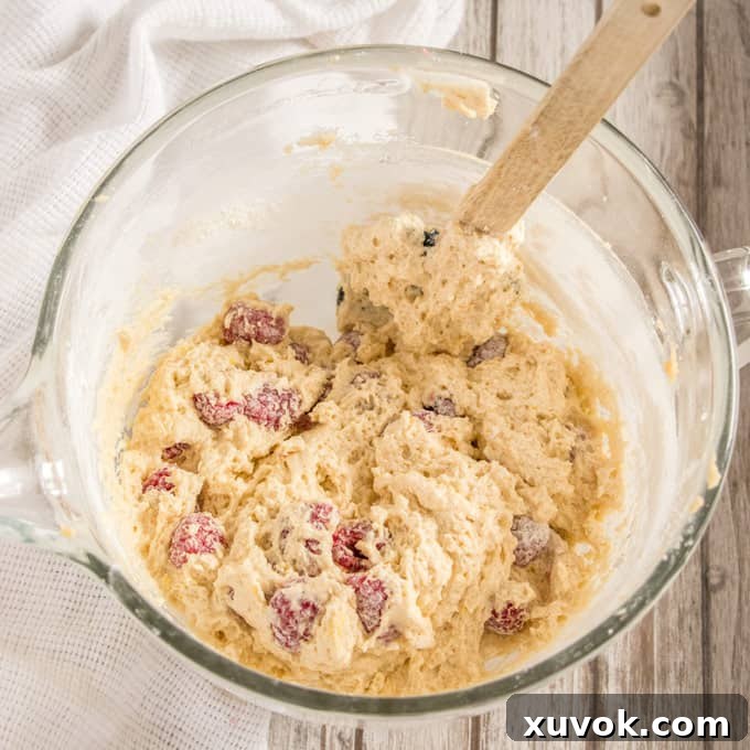 Mixing the batter for Lemon Raspberry Mini Bundt Cakes in a stand mixer.