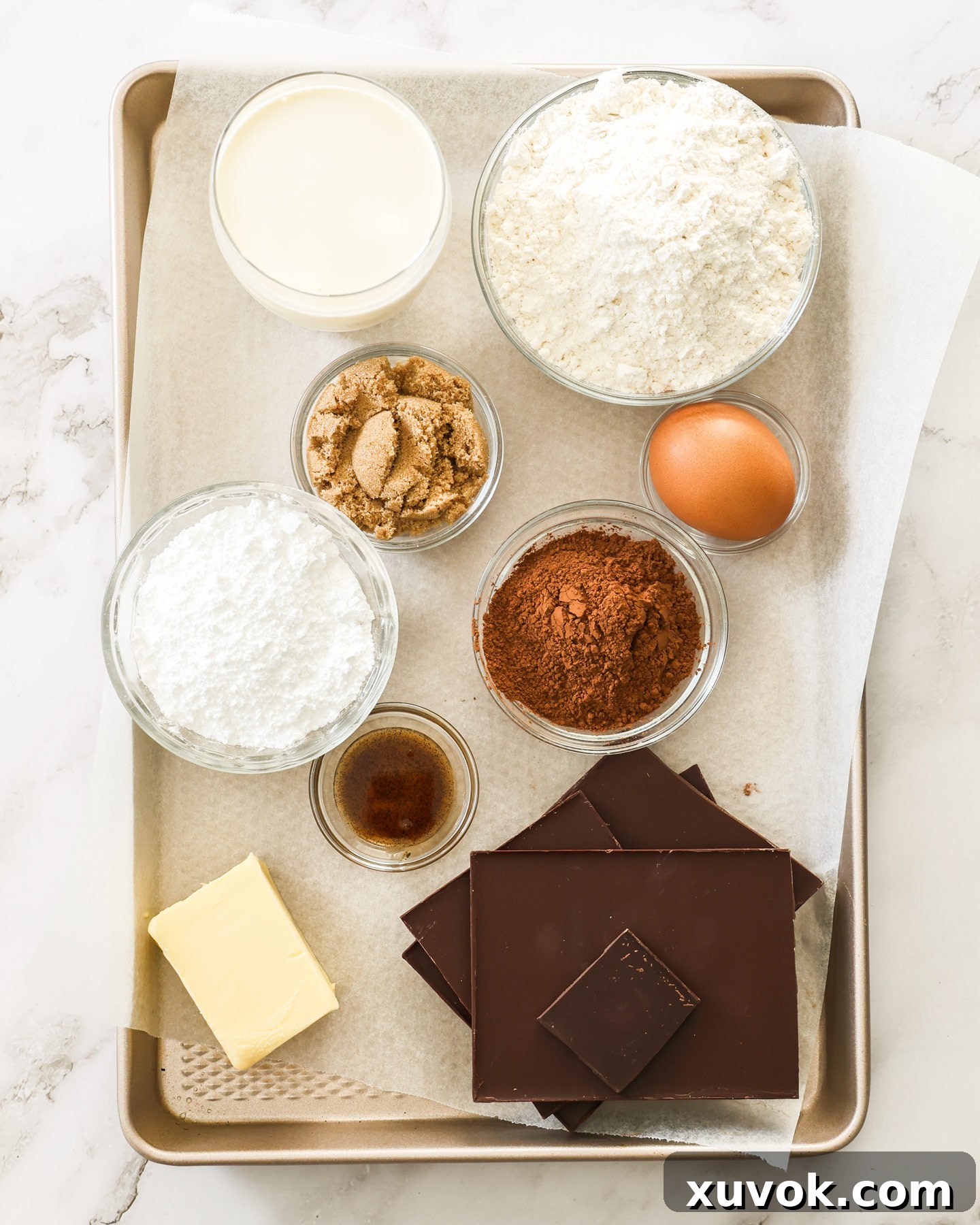 Ingredients for mini chocolate tarts on a baking tray.