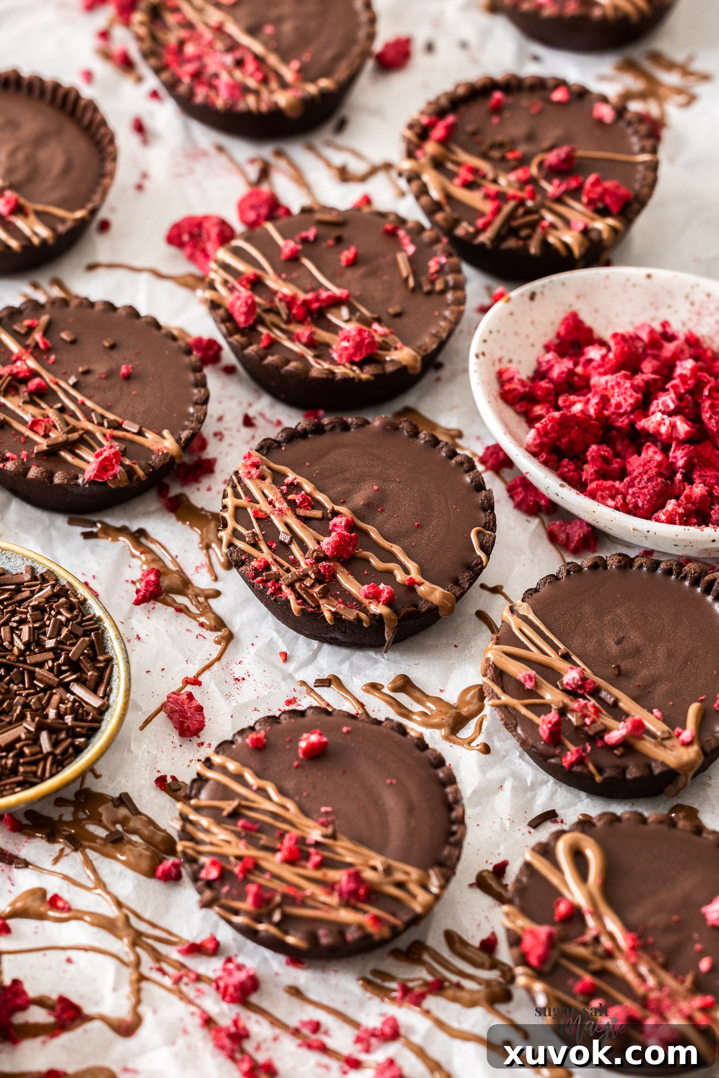 10 mini chocolate tarts drizzled with milk chocolate.