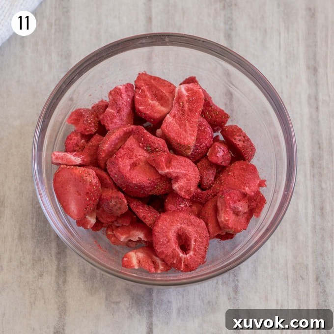 A small glass bowl filled with whole freeze-dried strawberries.