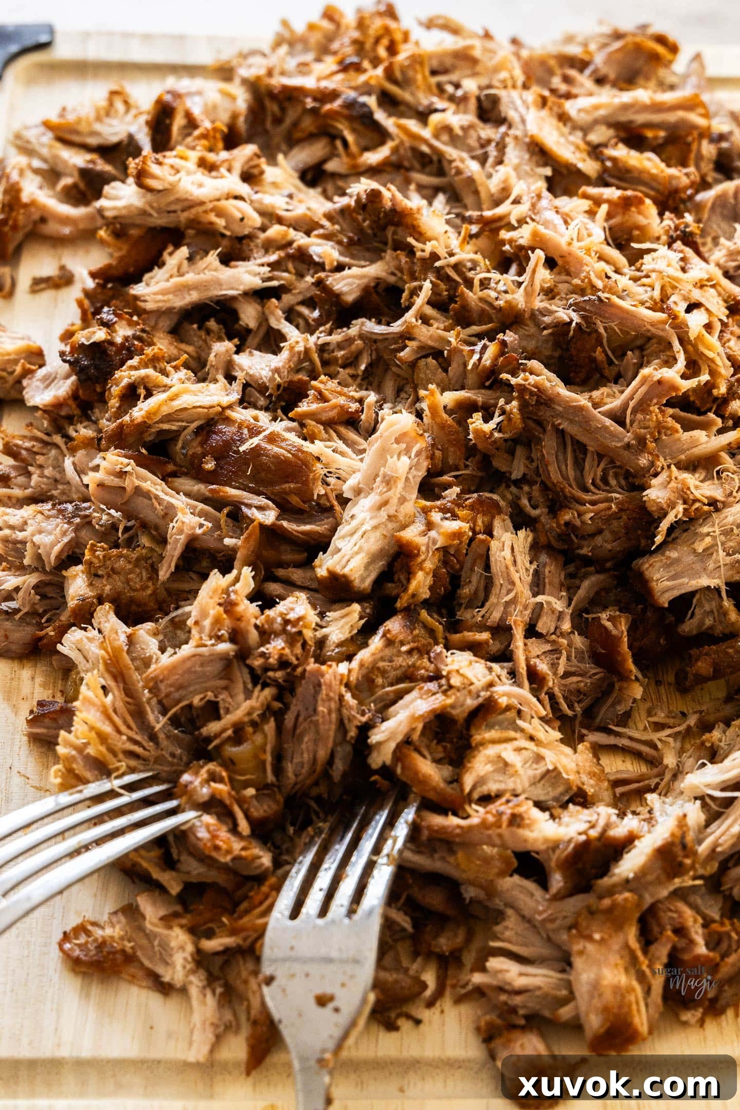 The pork shredded on a chopping board.