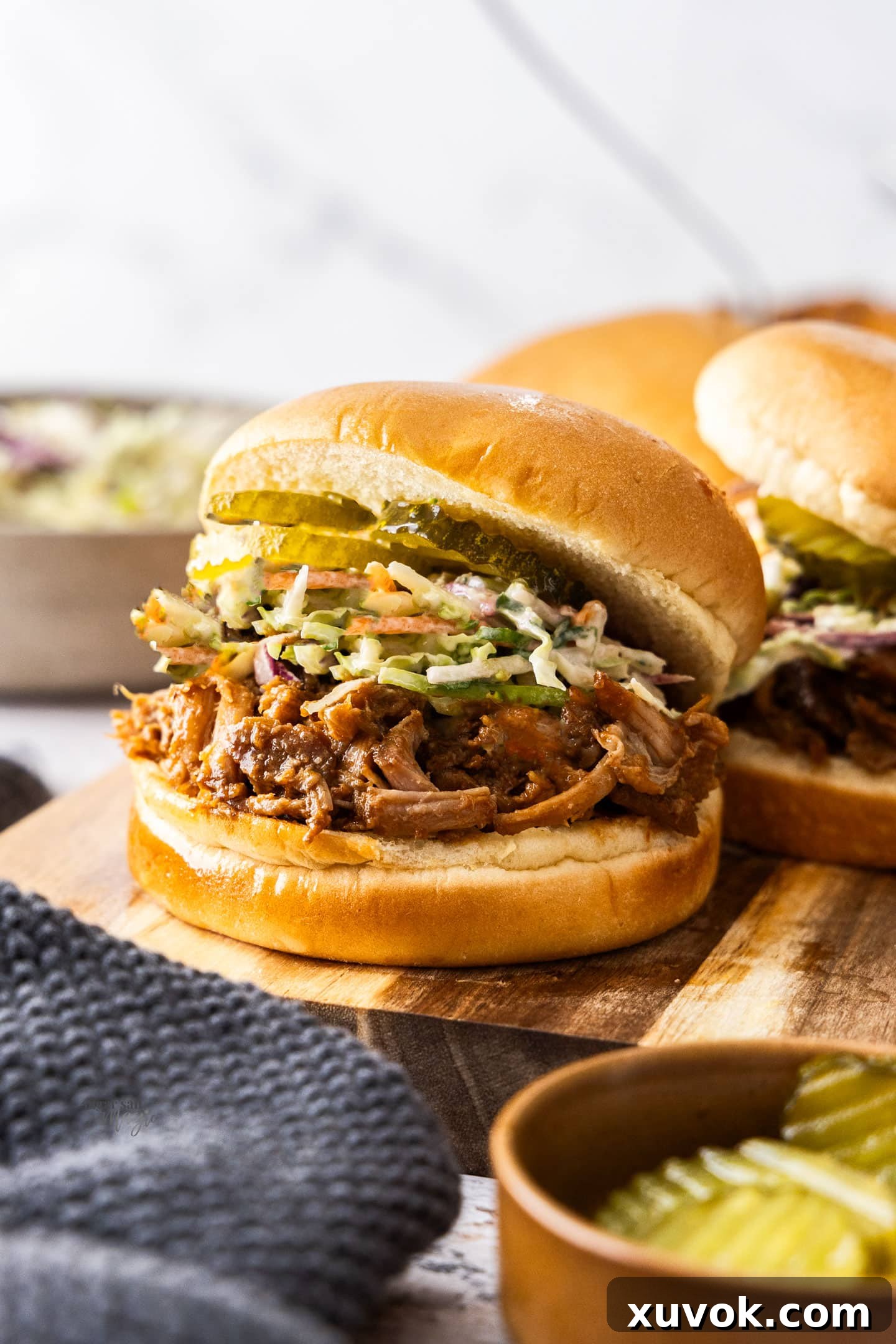 A burger filled with pulled pork and coleslaw.