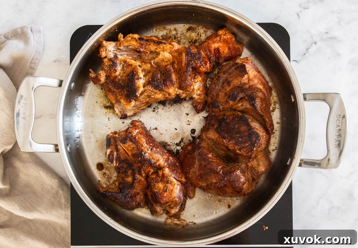 The pork in a pan, browned.