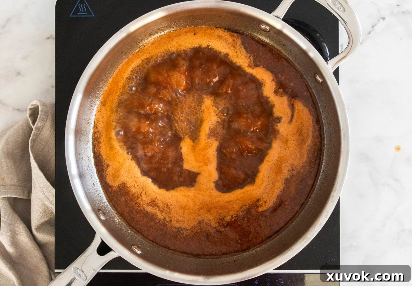 The sauce rapidly boiling in a pan.