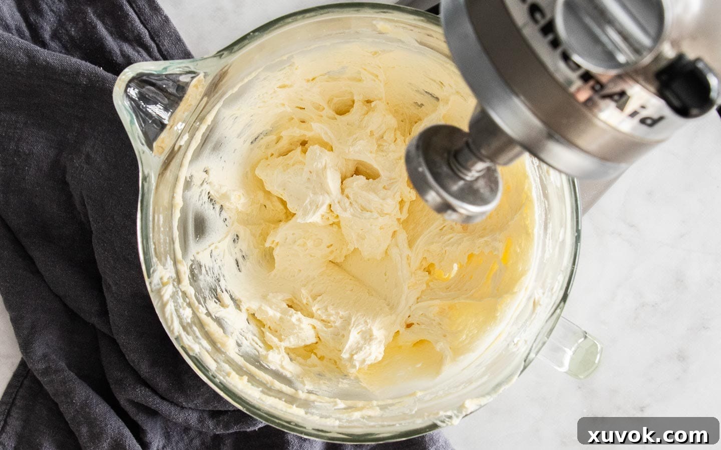 Smooth ermine buttercream in a mixing bowl before raspberry puree is added.