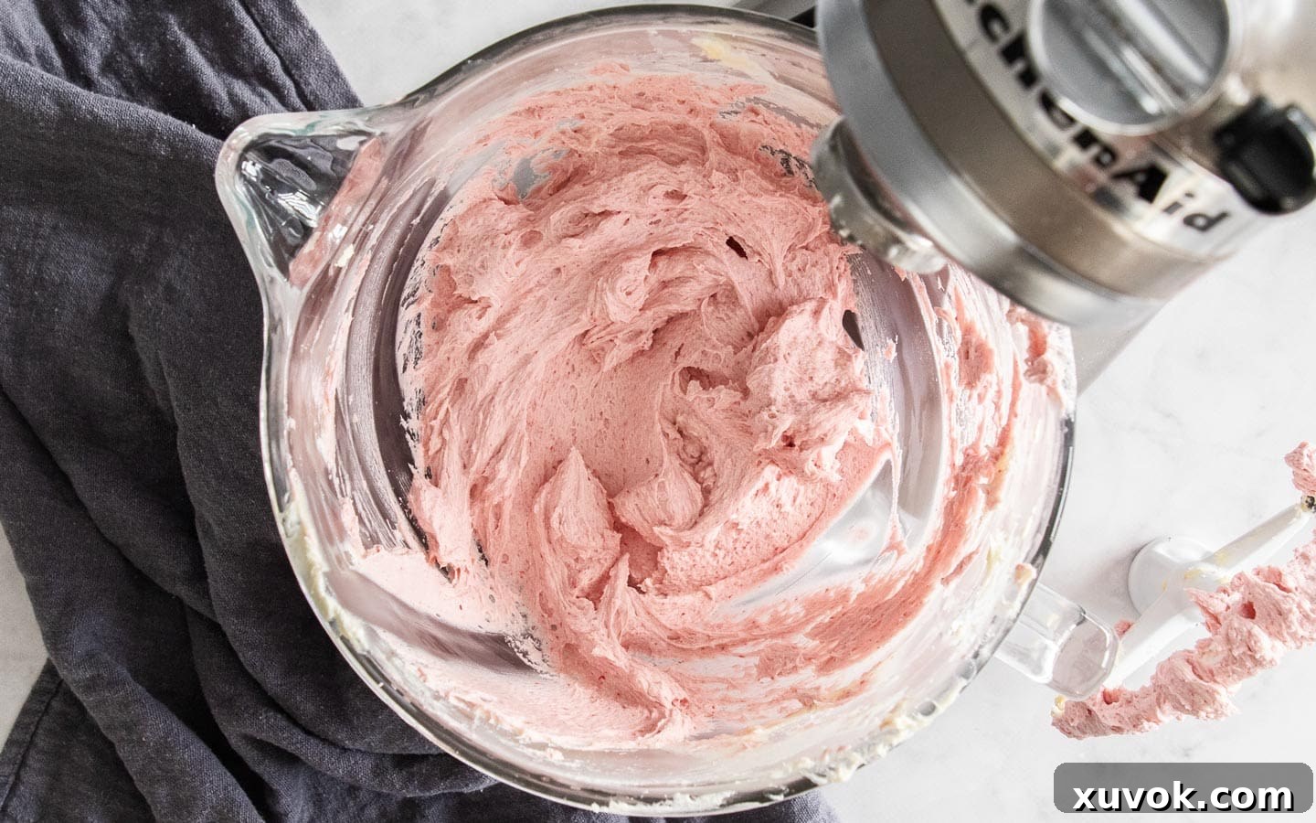 Vibrant raspberry buttercream ready in a mixing bowl.