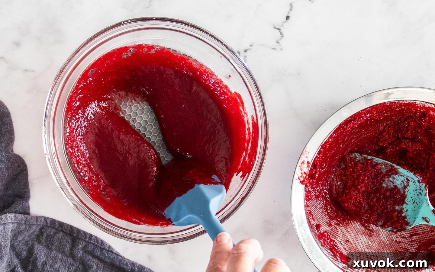 The smooth raspberry puree after being strained to remove seeds.