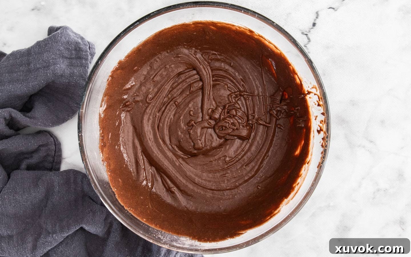 Chocolate cupcake batter in a mixing bowl, ready for baking.