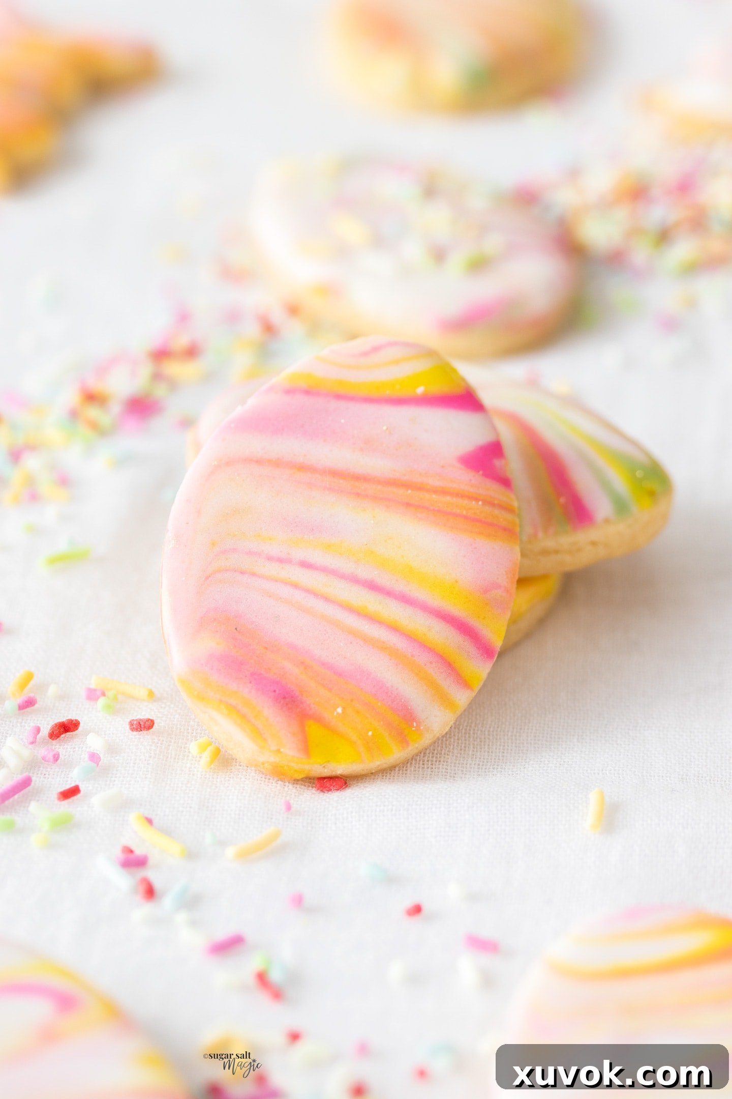 A small stack of marbled Easter sugar cookies, showcasing their intricate, colorful designs.