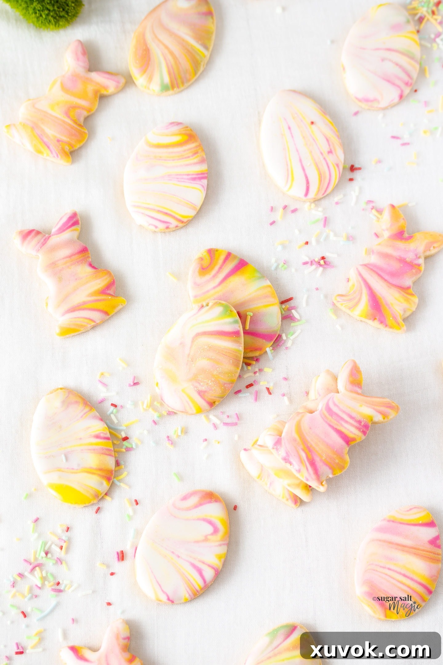 Top-down view of beautifully marbled egg and bunny-shaped sugar cookies, perfect for an Easter celebration.