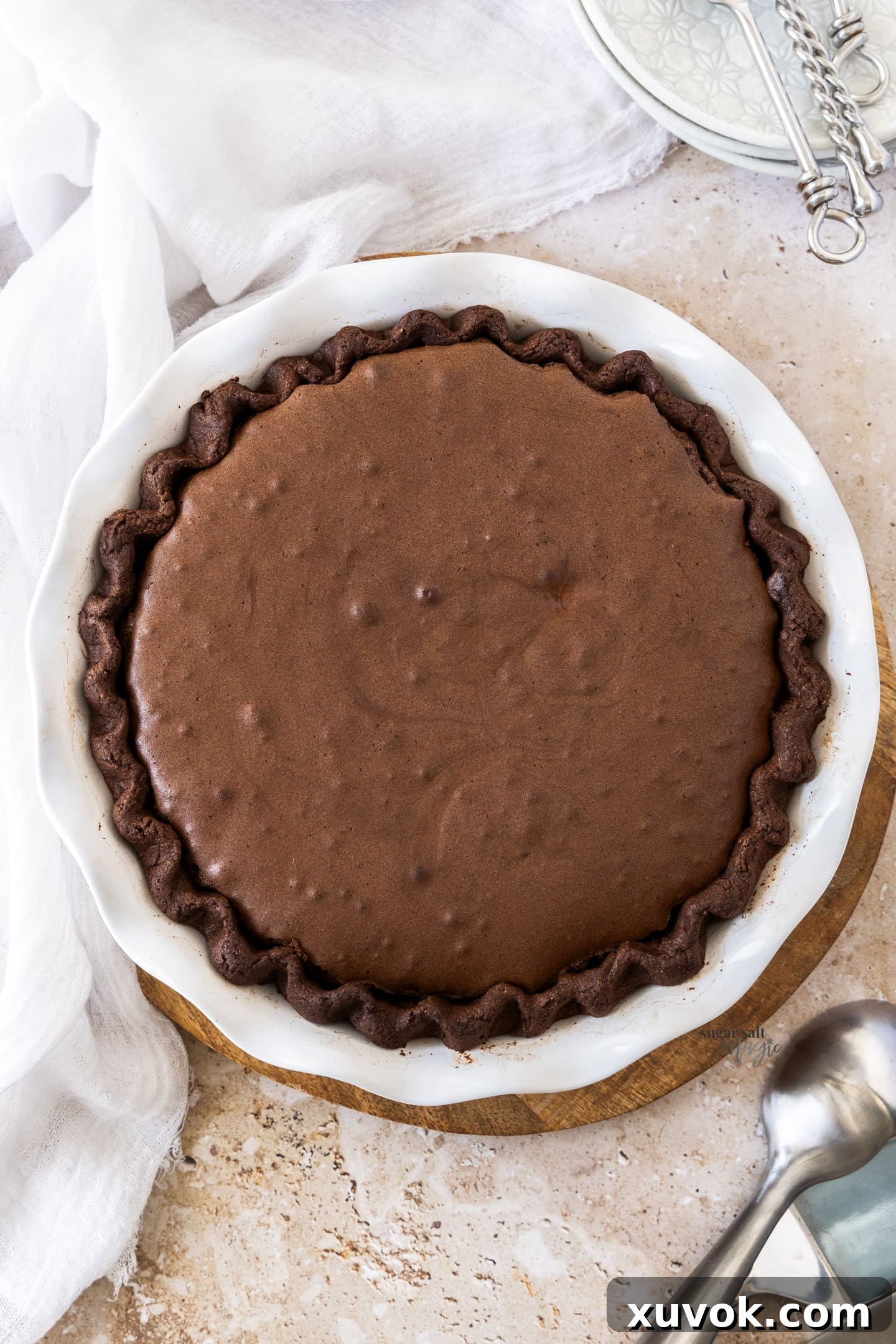 A beautiful top-down view of a freshly baked Chocolate Brownie Pie, showcasing its inviting crackly top and deep chocolate color.