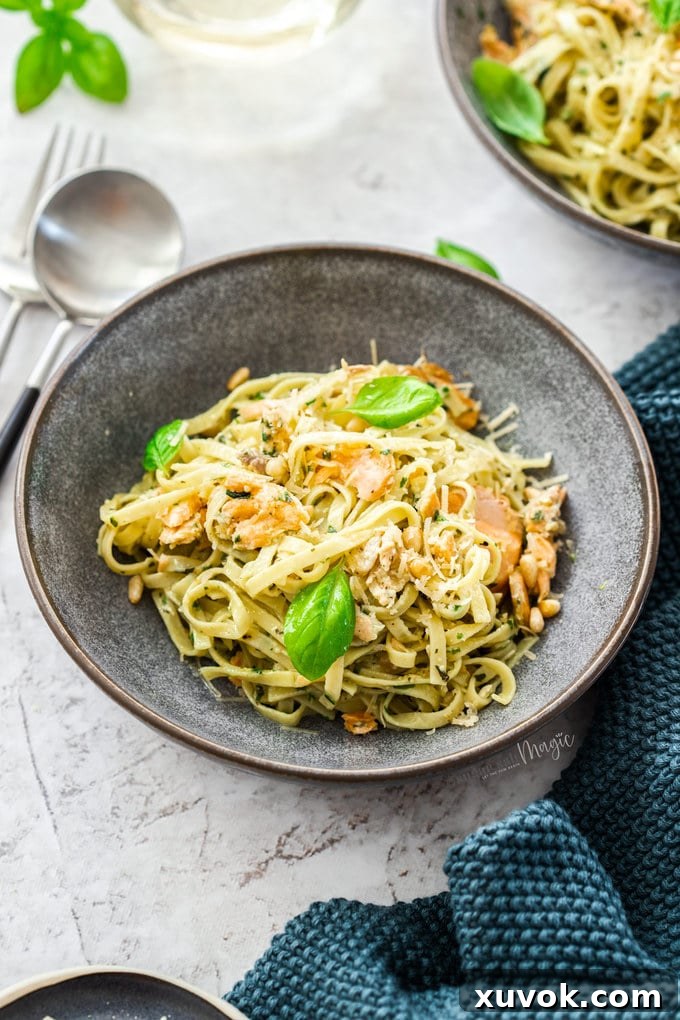 A grey bowl filled with salmon pasta.
