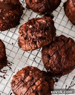 Top down view of 7 chocolate scones drizzled with chocolate.