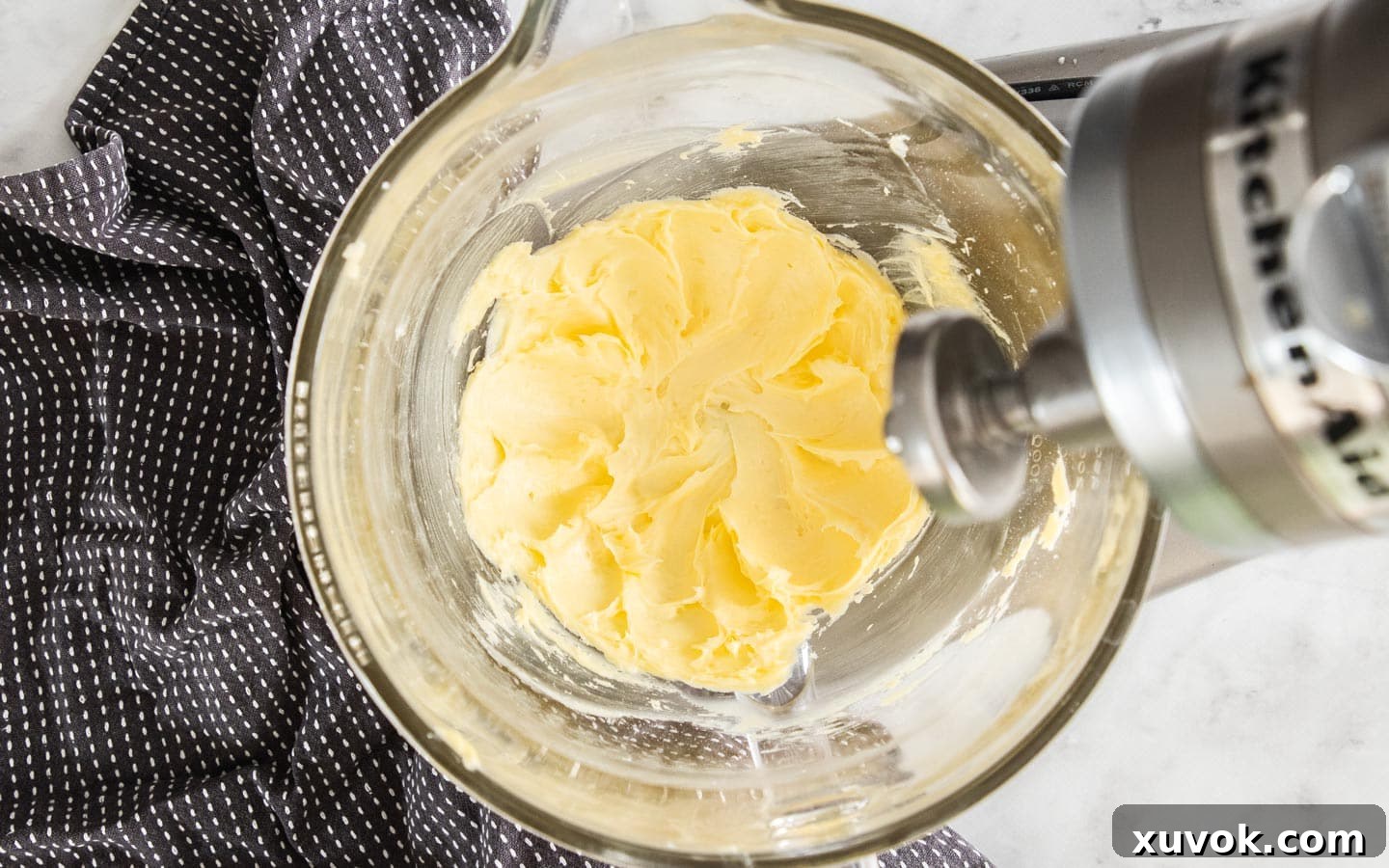 The perfectly creamed butter and sugar mixture, light and fluffy, ready for the next step in a pristine mixing bowl.