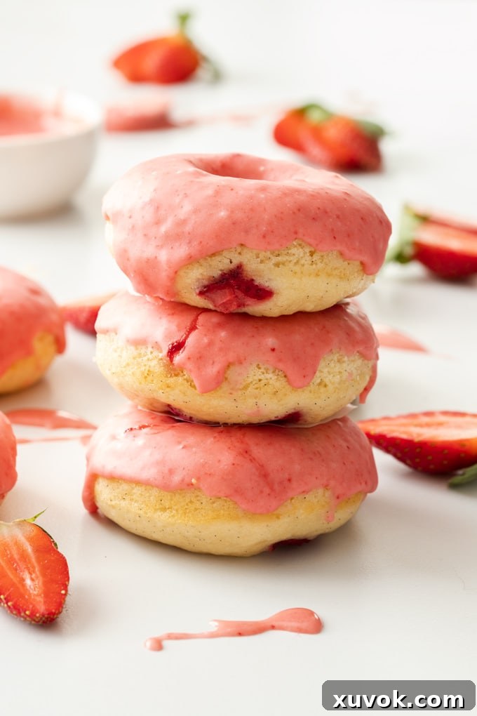 Delicious Baked Strawberry Doughnuts stacked with pink glaze