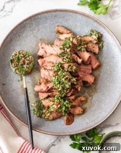 Birdseye view of a grey plate with sliced steak.