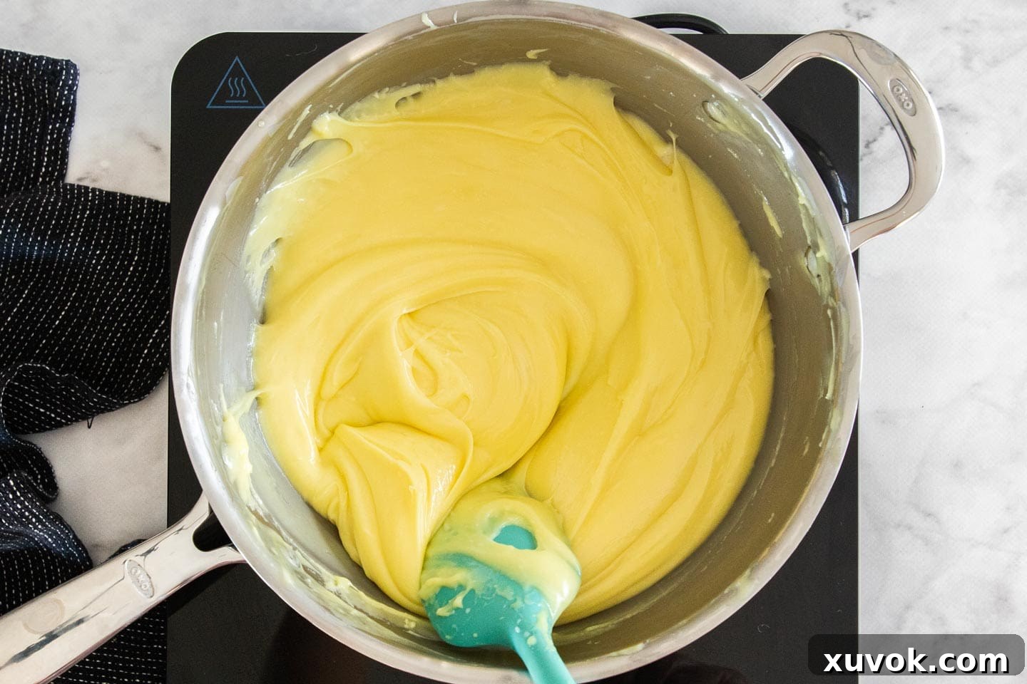 The lemon fudge mixture, now completely melted and smoothly combined, glistening in the saucepan.