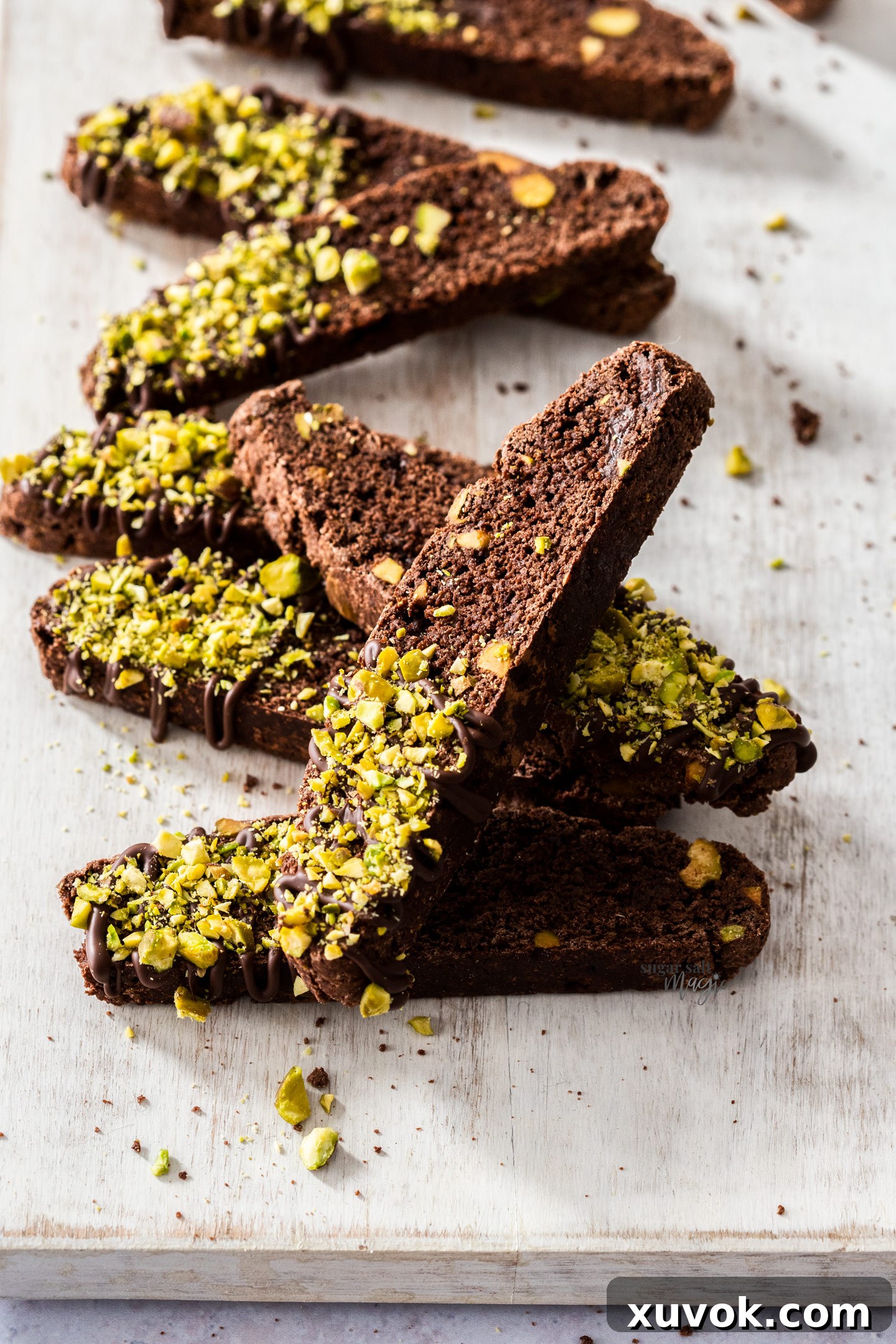 Chocolate biscotti lined up on a serving board.