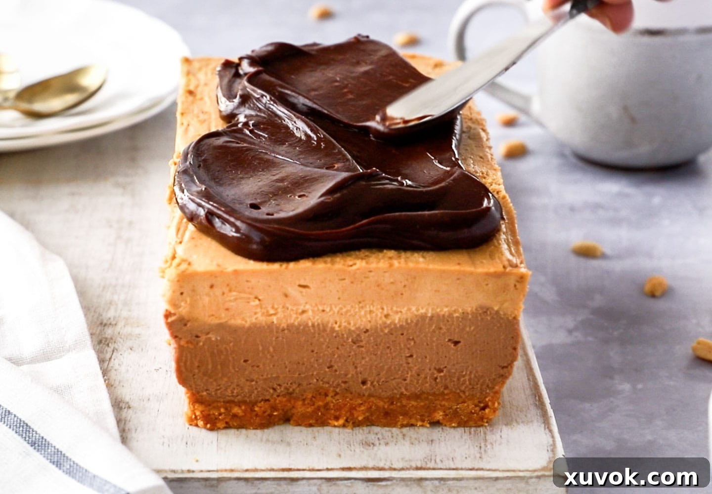 Spreading the ganache on top of the cheesecake.
