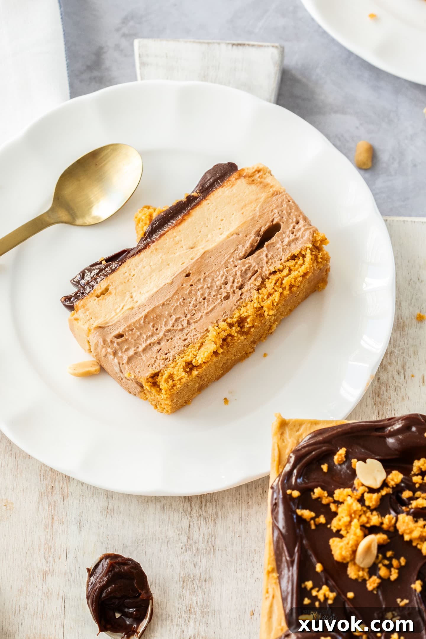 A slice of no bake peanut butter chocolate cheesecake on a dessert plate.