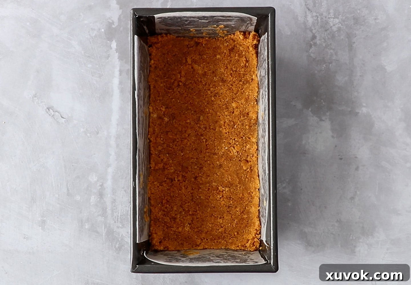 The cookie crust pressed into a loaf pan.