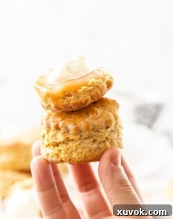 Two Blood Orange Scones being held up by a hand.