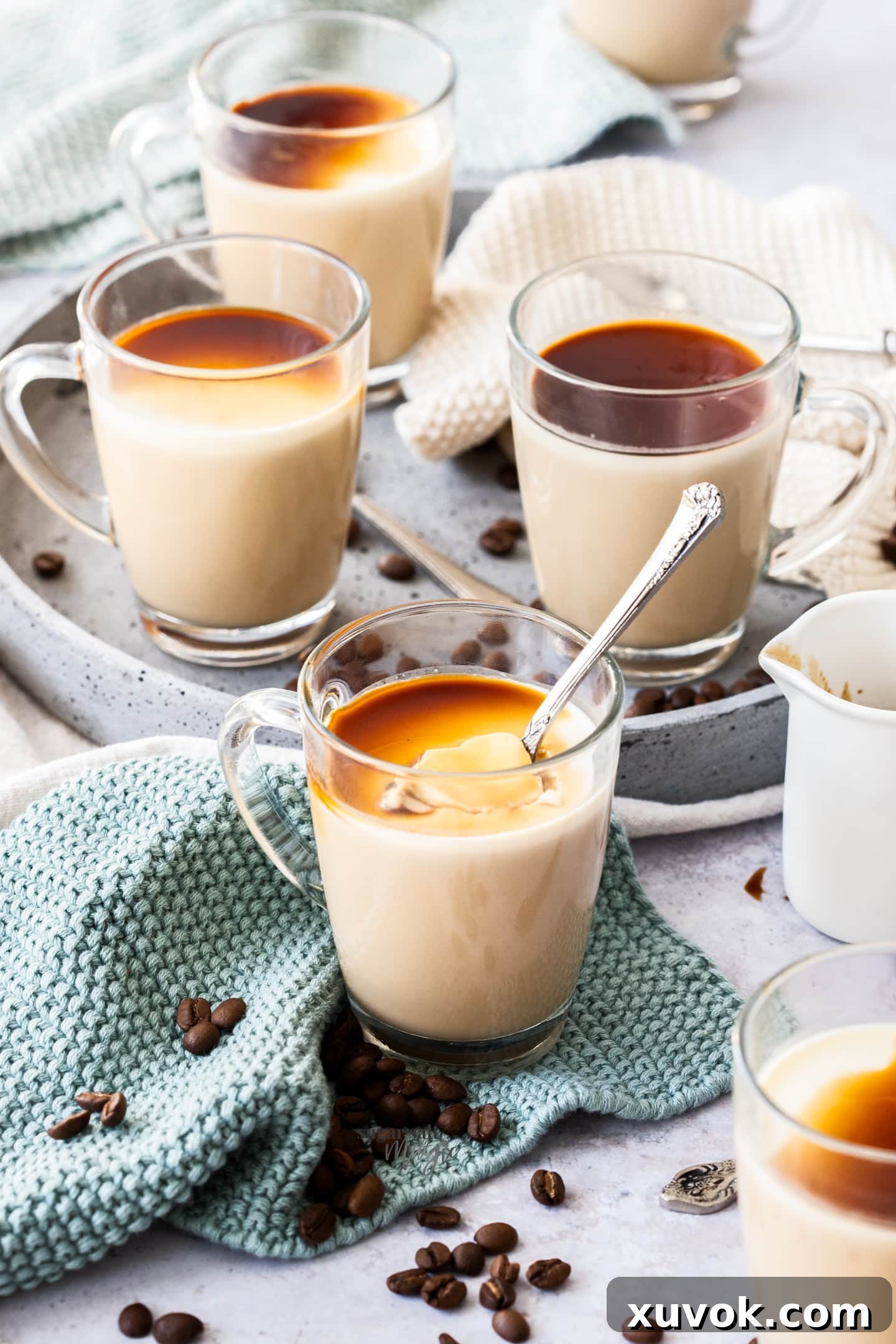 A batch of six elegantly prepared coffee panna cottas, served in small espresso glasses, showcasing their inviting layers.