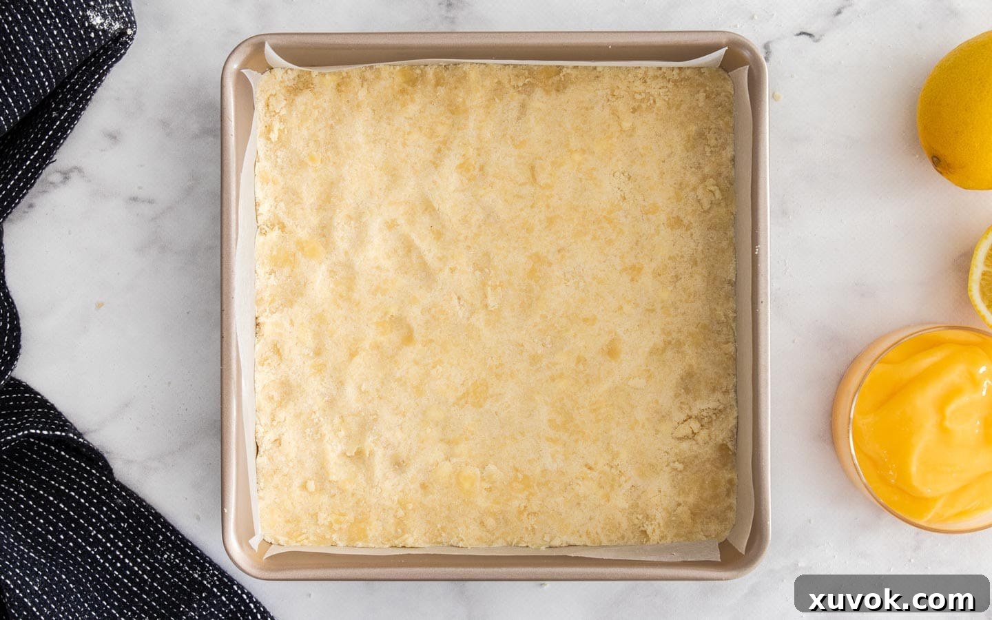 The shortbread mixture pressed into a square baking pan.