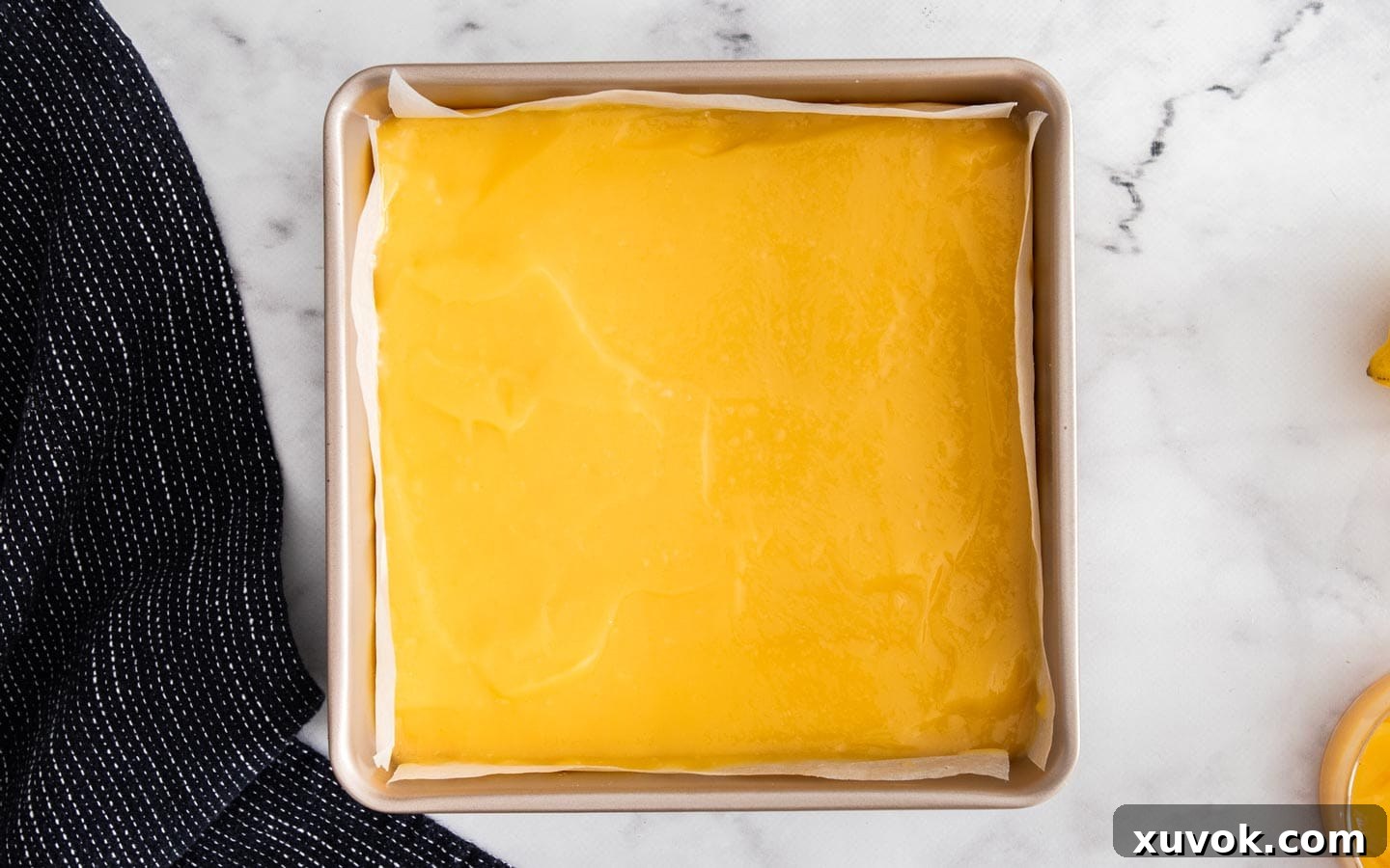 The lemon curd spread over the shortbread base.