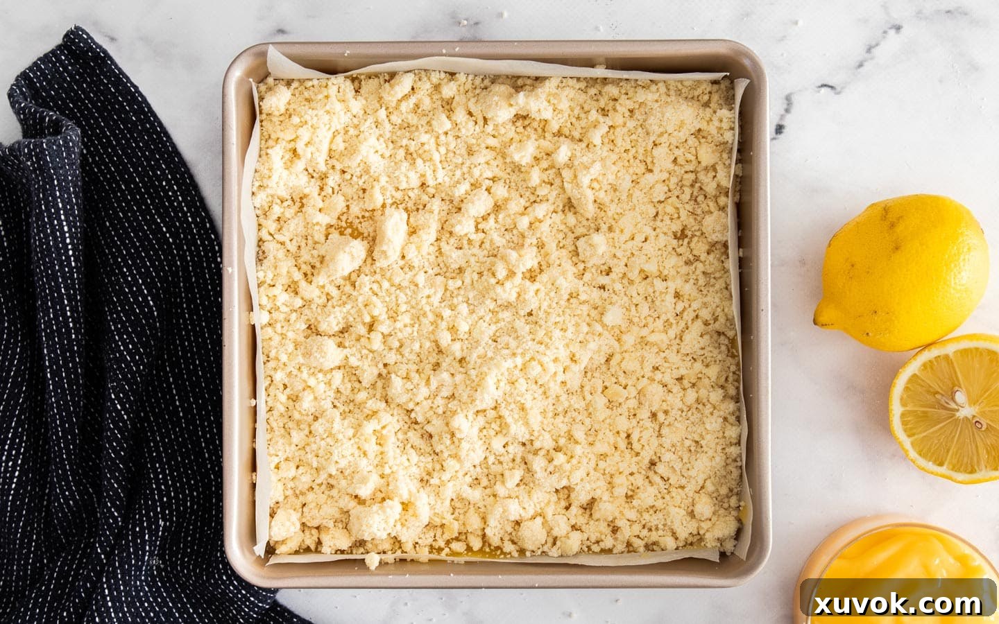 The crumb mixture on top of the lemon curd before baking.