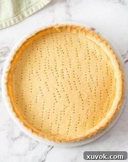 Top down view of a baked sweet shortcrust pastry tart shell.