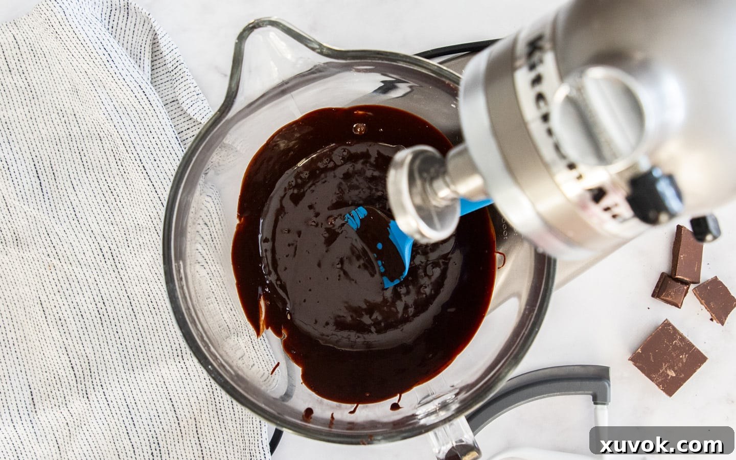 The chocolate butter mixture transferred to a mixing bowl after cooling slightly.
