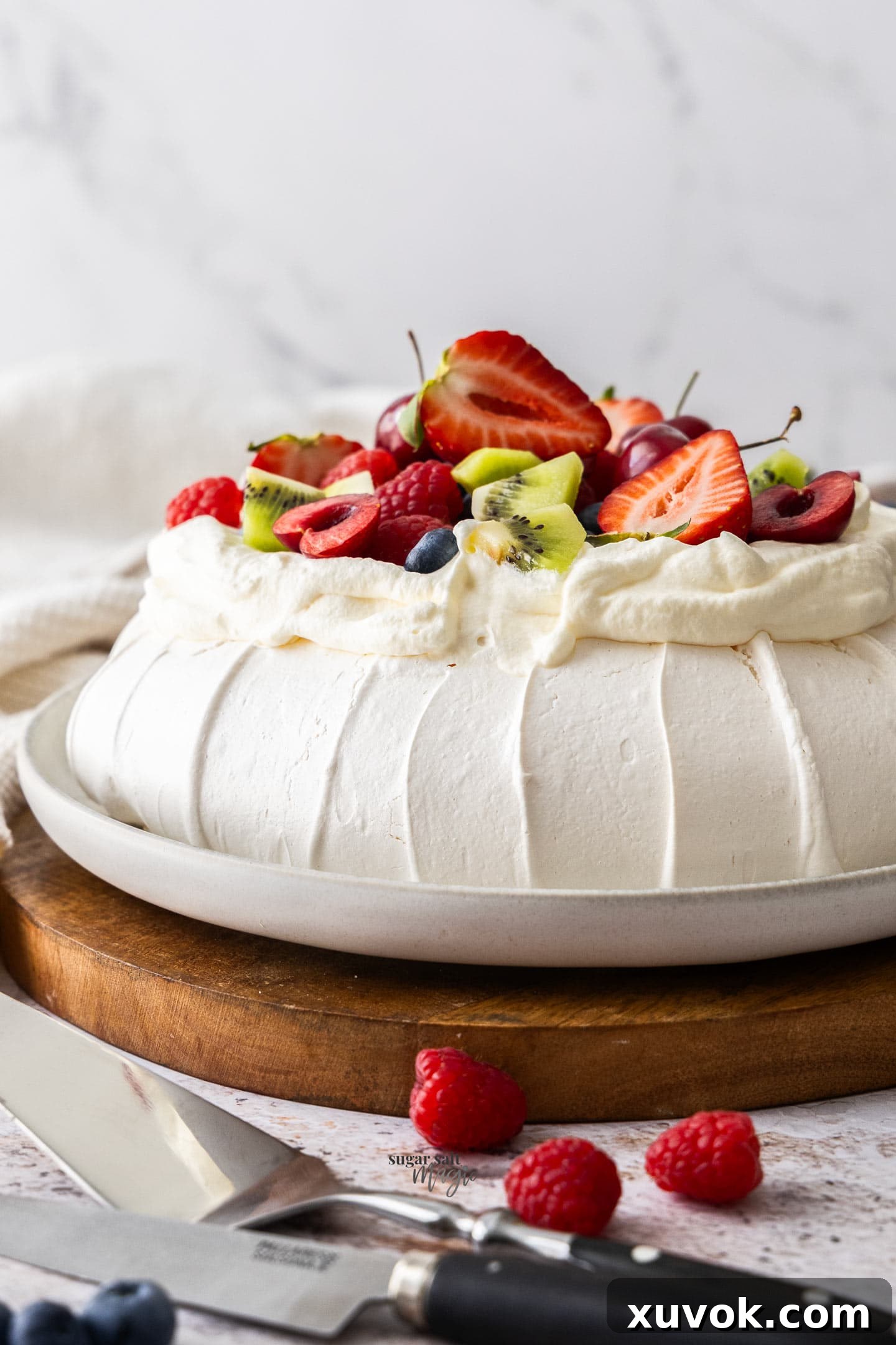 Profile view of the pavlova, showcasing its elegant height and crisp exterior.