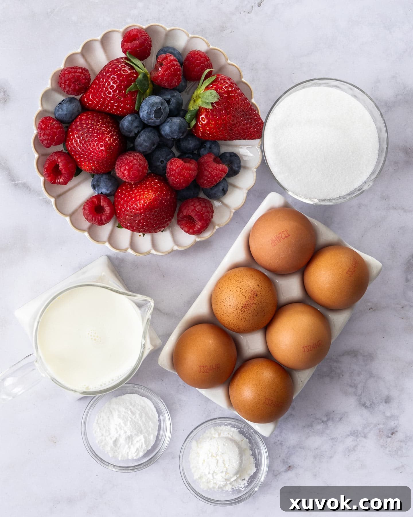 All the core ingredients for making pavlova laid out on a surface.