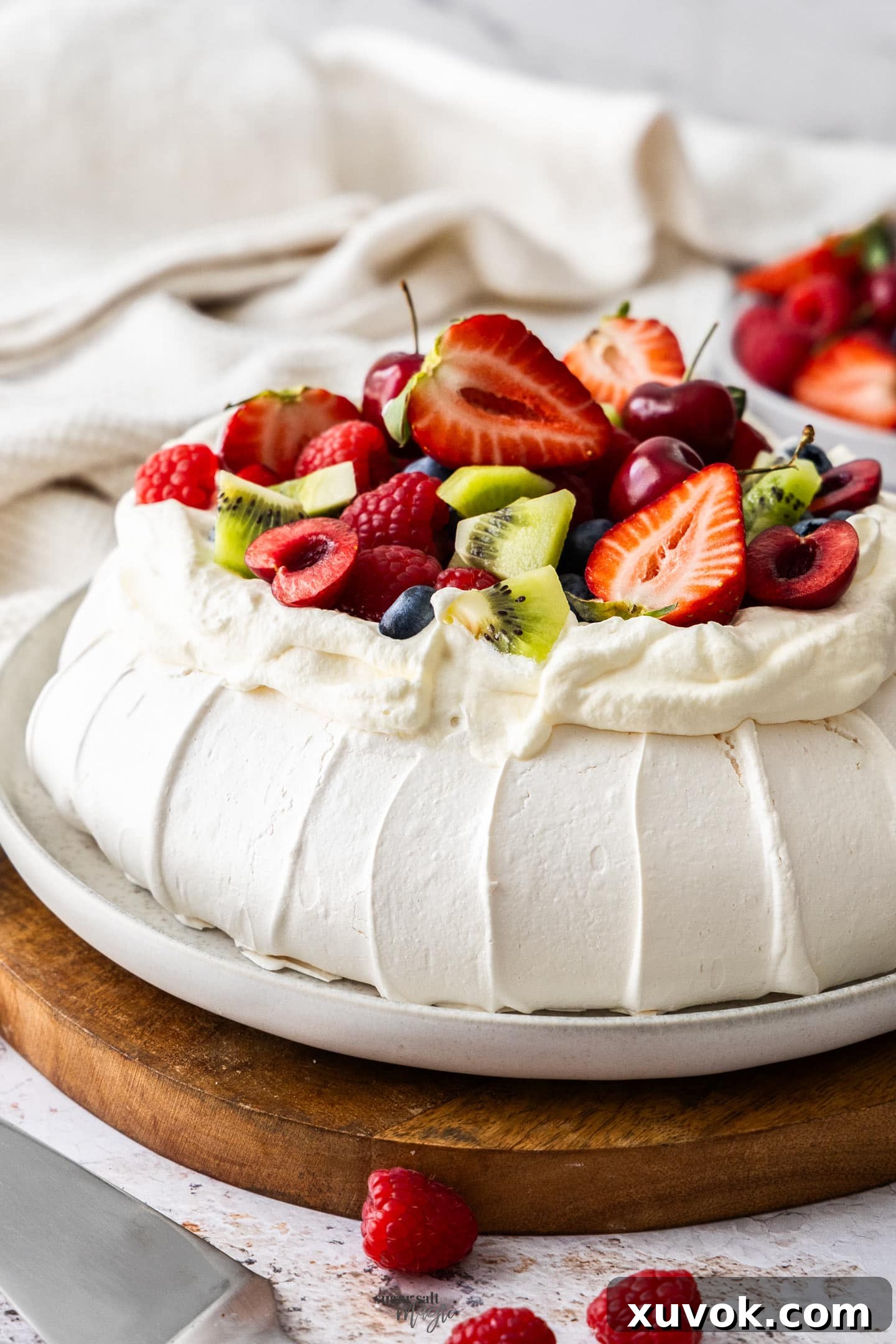 Closeup of the side of the pavlova, highlighting its crisp texture and layers.