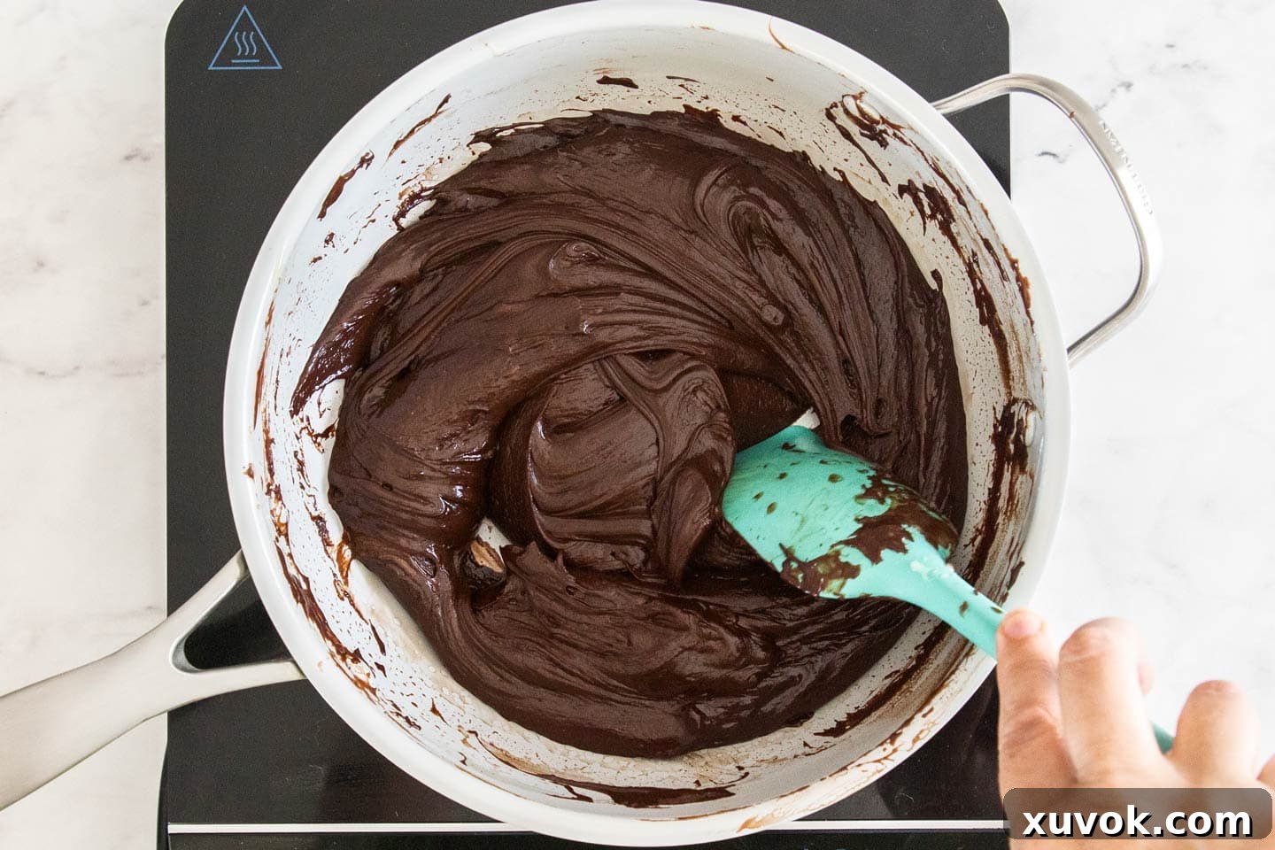 The dark chocolate fudge mixture, perfectly melted and smooth, glistening in a saucepan, ready for the next step.