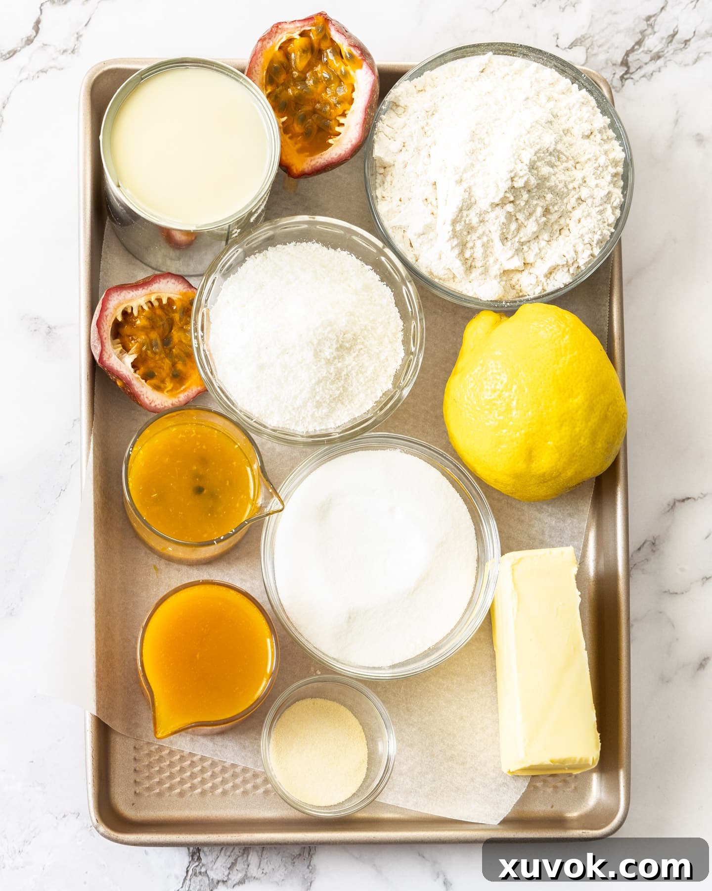 An array of fresh and pantry ingredients laid out, ready for making passionfruit slice.