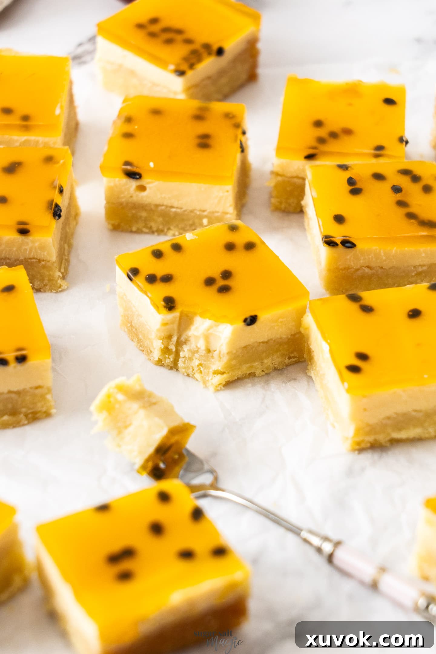 A single passionfruit slice on a plate, with a forkful taken out, showing its creamy texture.