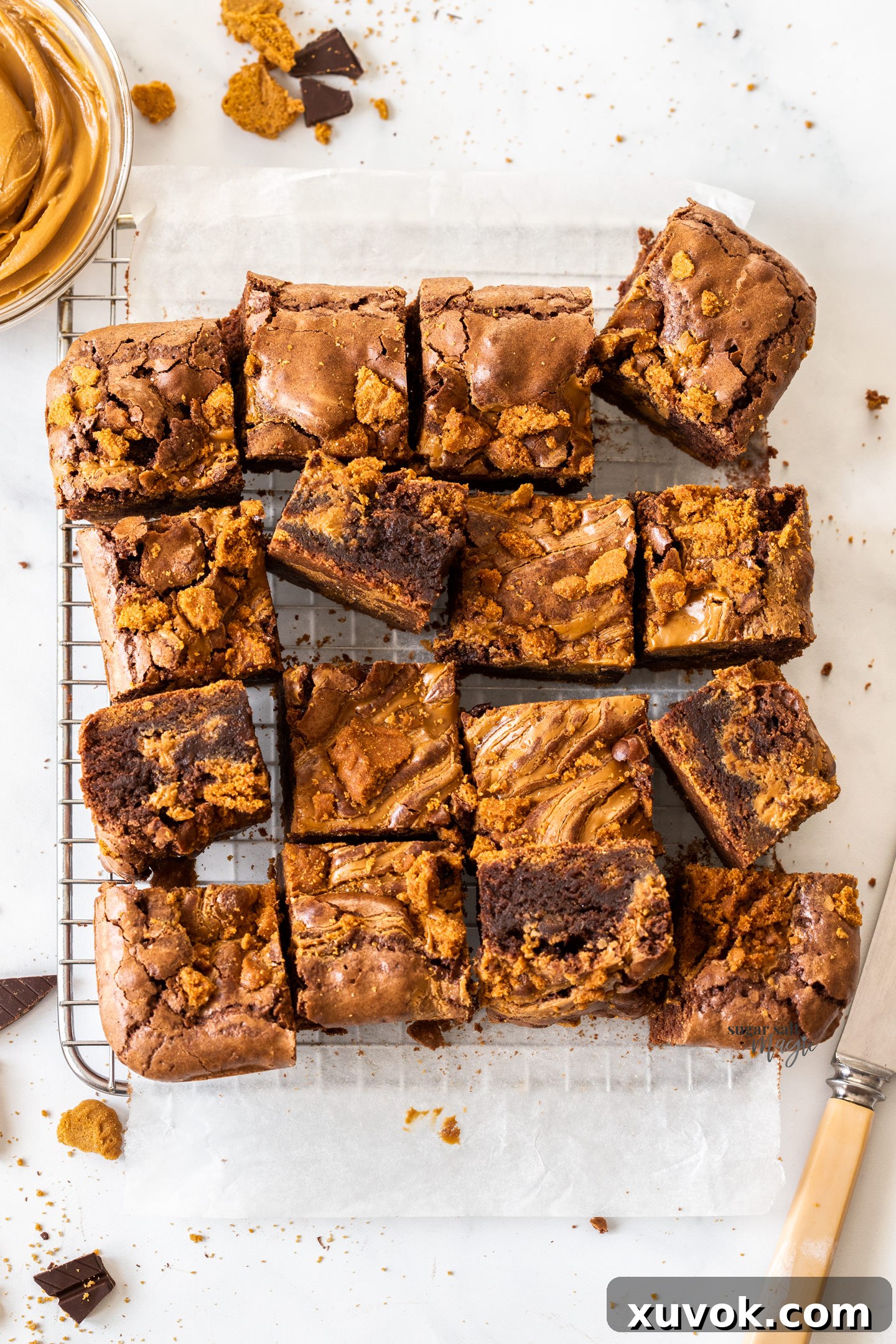 Top down view of a batch of brownies on a wire rack, showcasing the rich chocolate and Biscoff swirls.