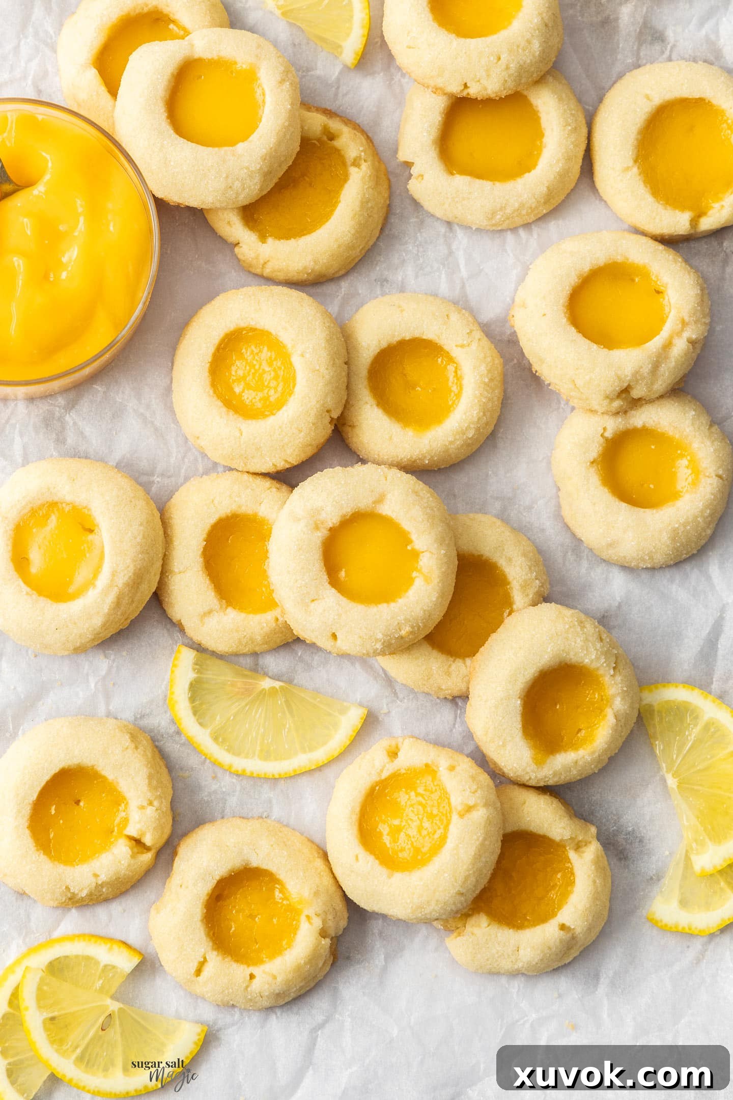 A stunning top-down view of a fresh batch of golden lemon curd cookies, artfully arranged to highlight their perfect round shape and glistening lemon centers, ready to be enjoyed.