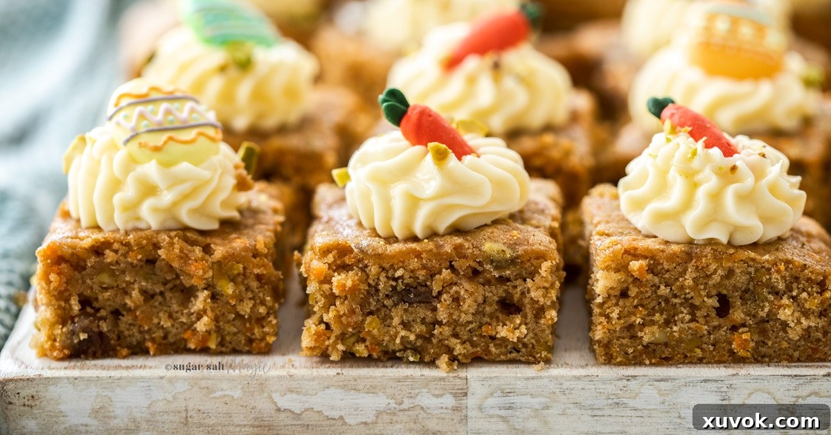 Closeup of 3 carrot cake bars on a white wooden board