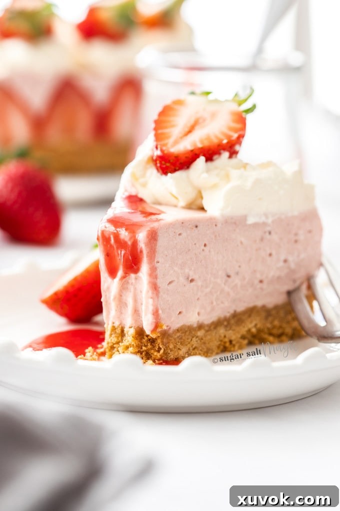 A slice of strawberry cheesecake with a bite taken out on a white plate