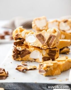 Two pieces of Caramel rocky road stacked on top of one another with other slices around.