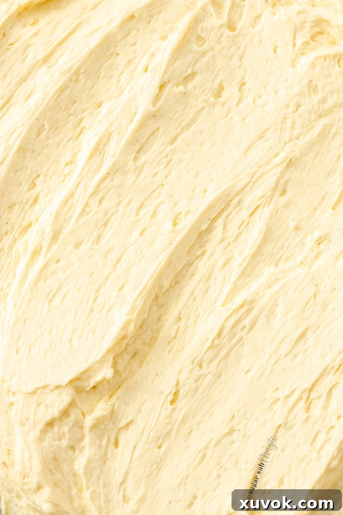 Closeup of swirls of buttercream, showcasing its smooth and creamy texture. Ideal for frosting cupcakes and cakes.