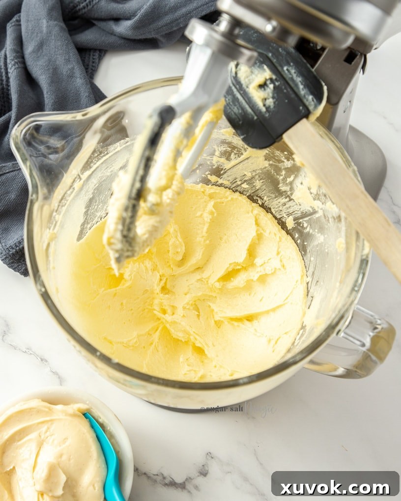 A stand mixer bowl showing perfectly whipped butter, light and airy, ready for the next step.