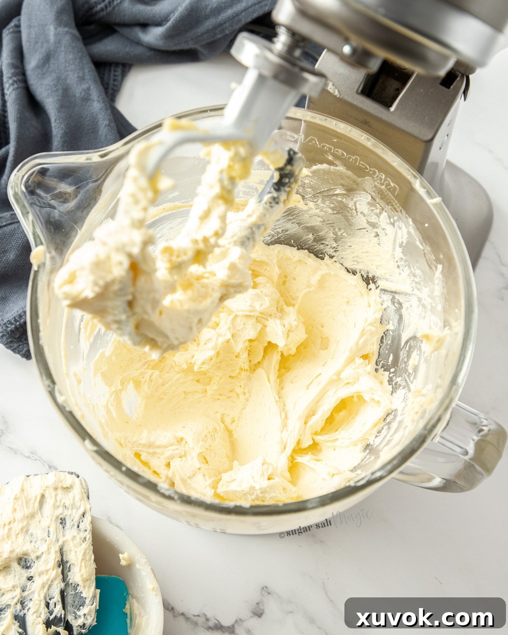 A stand mixer bowl filled with smooth, whipped buttercream, showing the successful combination of butter and custard.